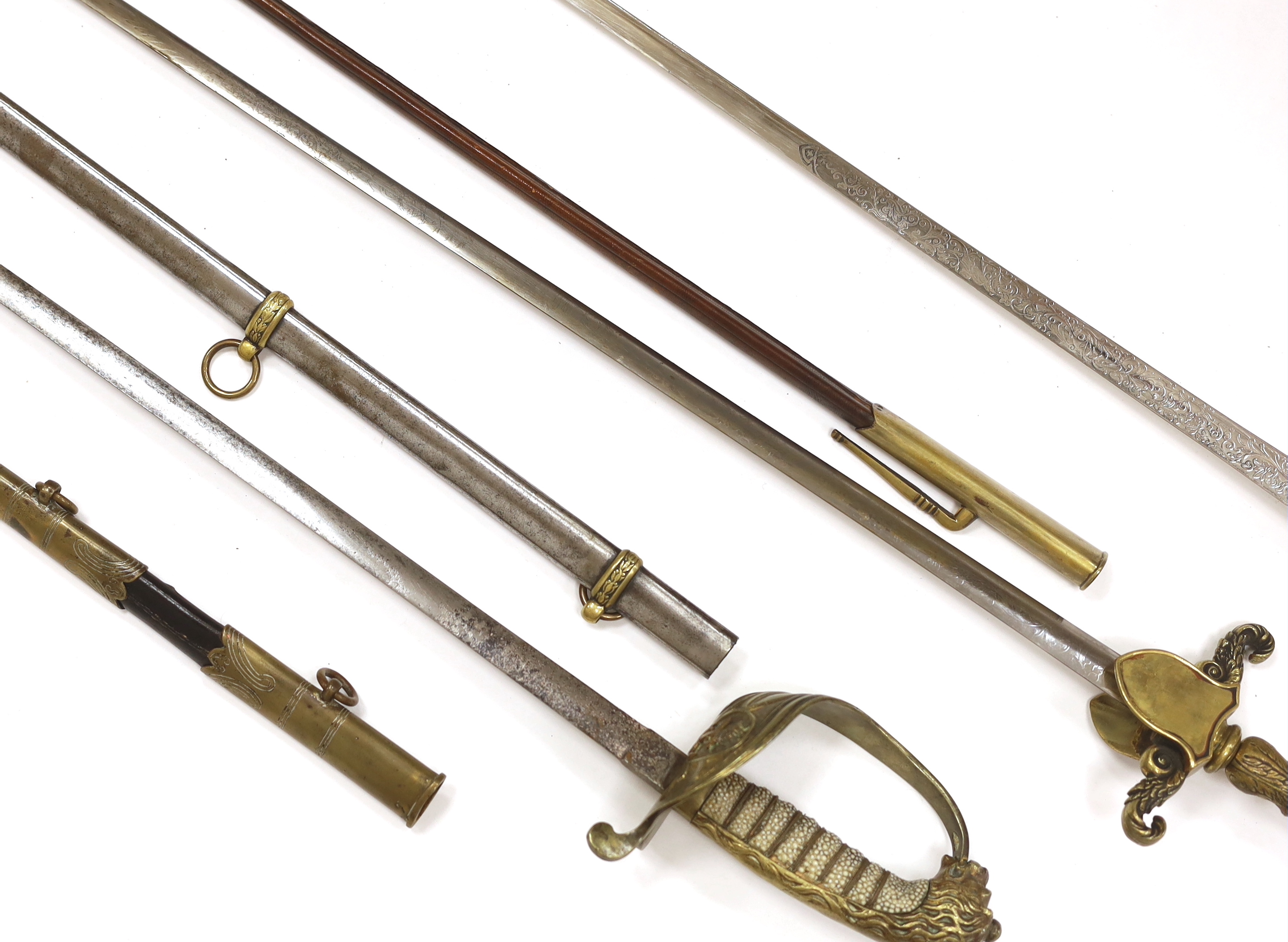 Three 20th century short swords; a court sword in a leather scabbard, a naval style sword, plus another with initials ‘MS’ to guard, blade 76cm